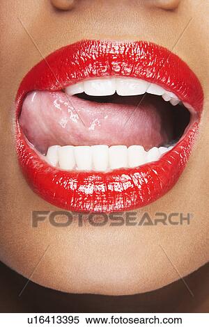 Stock Photography - Woman Licking Red Lips. Fotosearch