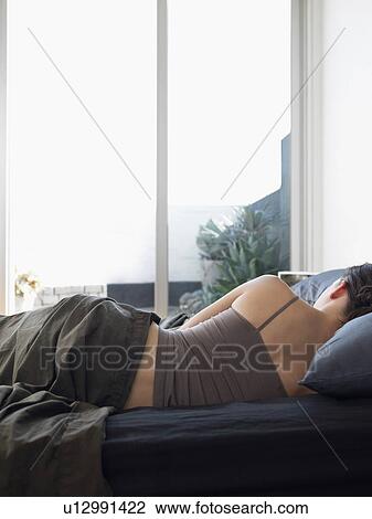 Woman lying on bed back view View Large Photo Image Stock Image - Woman lying on bed back view. Fotosearch