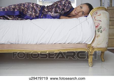 Woman lying on bed View Large Photo Image Stock Photo - Woman lying on bed. Fotosearch