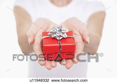 Woman offering small gift mid section close-up on hands View Large Photo Image Stock Image - Woman offering small gift mid section close-up on hands. Fotosearch
