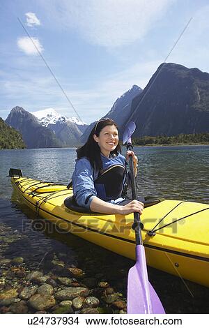 Woman paddling kayak in mountain lake View Large Photo Image Picture - Woman paddling kayak in mountain lake. Fotosearch