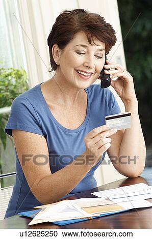 Woman paying credit card using cell phone View Large Photo Image Stock Image - Woman paying credit card using cell phone. Fotosearch