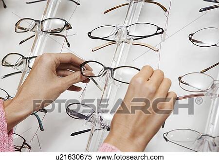 Woman pulling glasses from display rack close up of hands View Large Photo Image Stock Photography - Woman pulling glasses from display rack close up of hands. Fotosearch