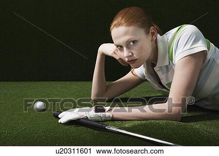 Woman reclining on floor with golf club and ball portrait View Large Photo Image Stock Image - Woman reclining on floor with golf club and ball portrait. Fotosearch