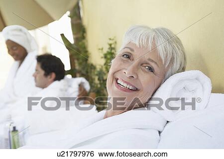 Woman relaxing at spa in bathrobe half length View Large Photo Image Stock Photograph - Woman relaxing at spa in bathrobe half length. Fotosearch