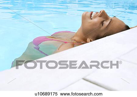 Woman Relaxing in Swimming Pool close up View Large Photo Image Stock Photography - Woman Relaxing in Swimming Pool close up. Fotosearch