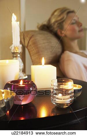 Woman Relaxing on sofa beside table with Candles View Large Photo Image Stock Image - Woman Relaxing on sofa beside table with Candles. Fotosearch