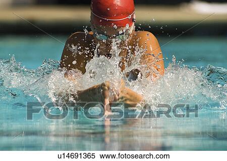 Stock Photography - Woman swimming in pool. Fotosearch