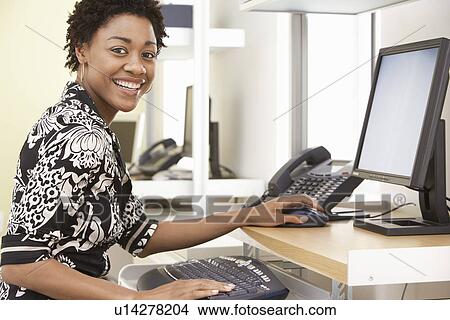 Picture - Woman using computer in office portrait. Fotosearch