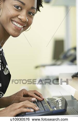 Woman using computer in office portrait View Large Photo Image Stock Photograph - Woman using computer in office portrait. Fotosearch