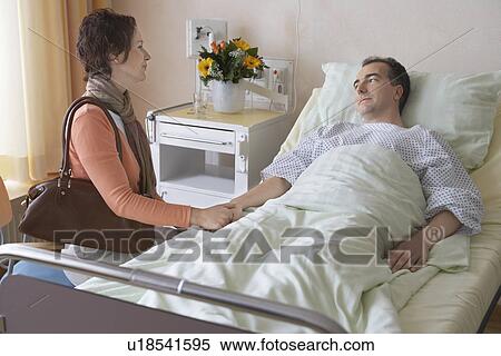 Stock Photography - Woman Visiting Husband in Hospital. Fotosearch