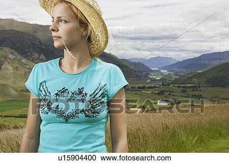 Woman wearing cowboy hat in countryside View Large Photo Image Stock Image - Woman wearing cowboy hat in countryside. Fotosearch