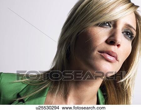 Woman with blonde hair head and shoulders in studio View Large Photo Image Picture - Woman with blonde hair head and shoulders in studio. Fotosearch
