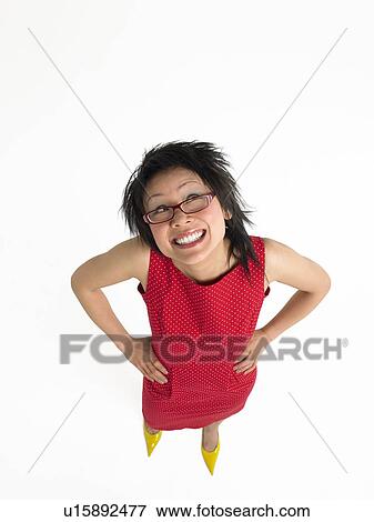 Woman with hands on hips in studio elevated view View Large Photo Image Stock Photo - Woman with hands on hips in studio elevated view. Fotosearch