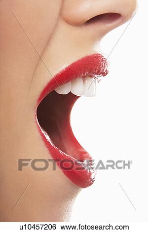Stock Photograph - Woman's open red lips yelling. Fotosearch