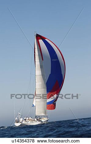 Stock Photo - Yacht on ocean with full sail side view. Fotosearch