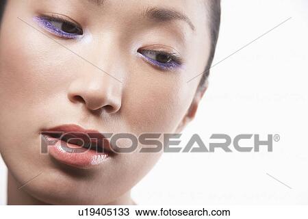 Stock Image - Young Asian woman head tilted. Fotosearch