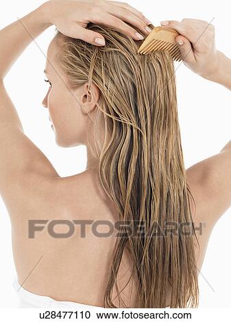 Young Blond Woman Combing wet Hair back view View Large Photo Image Stock Image - Young Blond Woman Combing wet Hair back view. Fotosearch