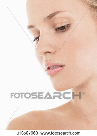 Stock Image - Young blonde Woman looking down close up. Fotosearch