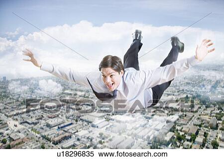 Young businessman flying over city View Large Photo Image Stock Photography - Young businessman flying over city. Fotosearch