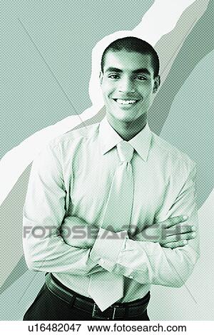 Stock Photo - Young businessman with arms crossed color enhanced. Fotosearch