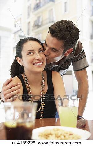 Young couple at sidewalk cafe man kissing woman portrait View Large Photo Image Stock Photography - Young couple at sidewalk cafe man kissing woman portrait. Fotosearch