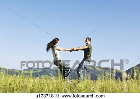 Young couple dancing in mountain field side view ground view View Large Photo Image Stock Photo - Young couple dancing in mountain field side view ground view. Fotosearch