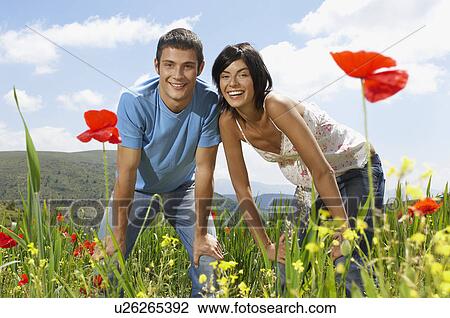 Young couple standing in mountain meadow portrait front view View Large Photo Image Stock Image - Young couple standing in mountain meadow portrait front view. Fotosearch