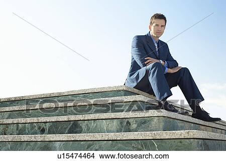 Young man wearing suit sitting on marble staircase outdoors portrait. View Large Photo Image Picture - Young man wearing suit sitting on marble staircase outdoors portrait.. Fotosearch