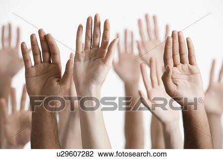 Stock Image - Young men and women raising hands close-up of hands. Fotosearch