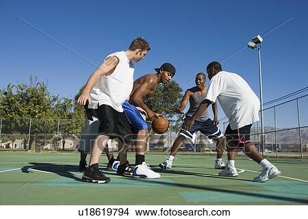 Young men playing basketball View Large Photo Image Picture - Young men playing basketball. Fotosearch