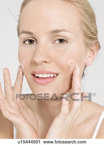 Young Woman Applying Facial Cream portrait close up View Large Photo Image Stock Image - Young Woman Applying Facial Cream portrait close up. Fotosearch