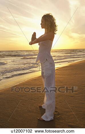 Young woman doing Tai Chi on beach side view View Large Photo Image Stock Image - Young woman doing Tai Chi on beach side view. Fotosearch
