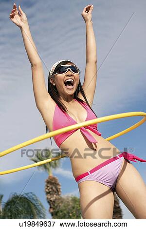 Young woman in bikini with hoop View Large Photo Image Stock Photo - Young woman in bikini with hoop. Fotosearch