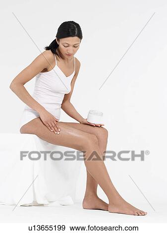 Young Woman in underwear Applying Body Lotion to thighs View Large Photo Image Stock Photo - Young Woman in underwear Applying Body Lotion to thighs. Fotosearch