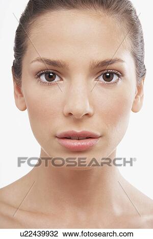 Stock Image - Young Woman looking vacantly into camera. Fotosearch