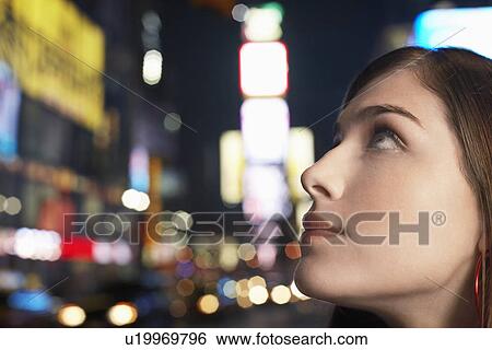 Stock Photograph - Young Woman on Nighttimes City Street close up profile. Fotosearch