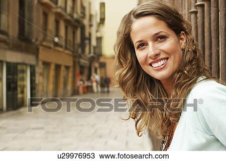 Young woman standing outside buildings in street portrait. View Large Photo Image Stock Image - Young woman standing outside buildings in street portrait.. Fotosearch