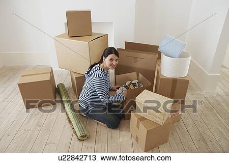Young Woman Unpacking Boxes View Large Photo Image Stock Image - Young Woman Unpacking Boxes. Fotosearch