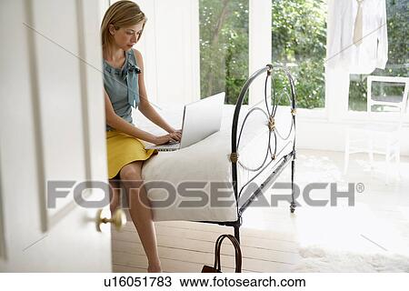 Young Woman Using Laptop on Bed View Large Photo Image Stock Image - Young Woman Using Laptop on Bed. Fotosearch