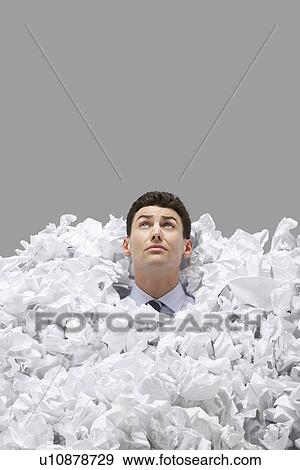 Adult man covered in crumpled paper looking up View Large Photo Image Stock Photo - Adult man covered in crumpled paper looking up. Fotosearch