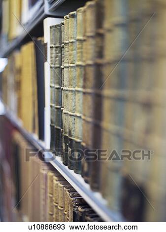 Stock Image - Antique books on shelf. Fotosearch