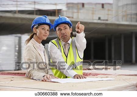 Stock Photo - Architect and construction manager having consultation. Fotosearch