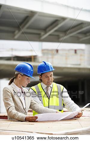 Stock Photography - Architect and construction manager having consultation. Fotosearch