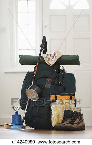 Stock Image - Backpack and camping equipment in hallway. Fotosearch