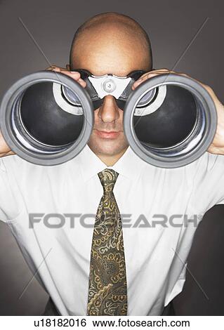 Balding Middle-aged businessman looking through large binoculars View Large Photo Image Stock Photograph - Balding Middle-aged businessman looking through large binoculars. Fotosearch