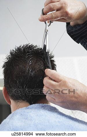Barber cutting mans hair in barber shop close-up View Large Photo Image Picture - Barber cutting mans hair in barber shop close-up. Fotosearch