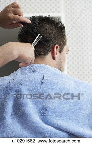 Barber cutting mans hair in barber shop View Large Photo Image Stock Image - Barber cutting mans hair in barber shop. Fotosearch