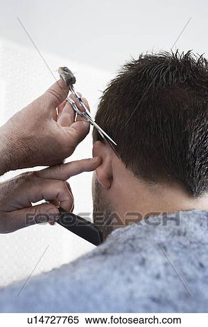 Barber cutting mans hair in barber shop View Large Photo Image Stock Photography - Barber cutting mans hair in barber shop. Fotosearch