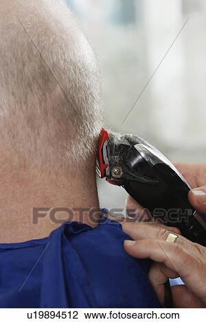 Barber shaving mans head in barber shop close-up View Large Photo Image Stock Image - Barber shaving mans head in barber shop close-up. Fotosearch
